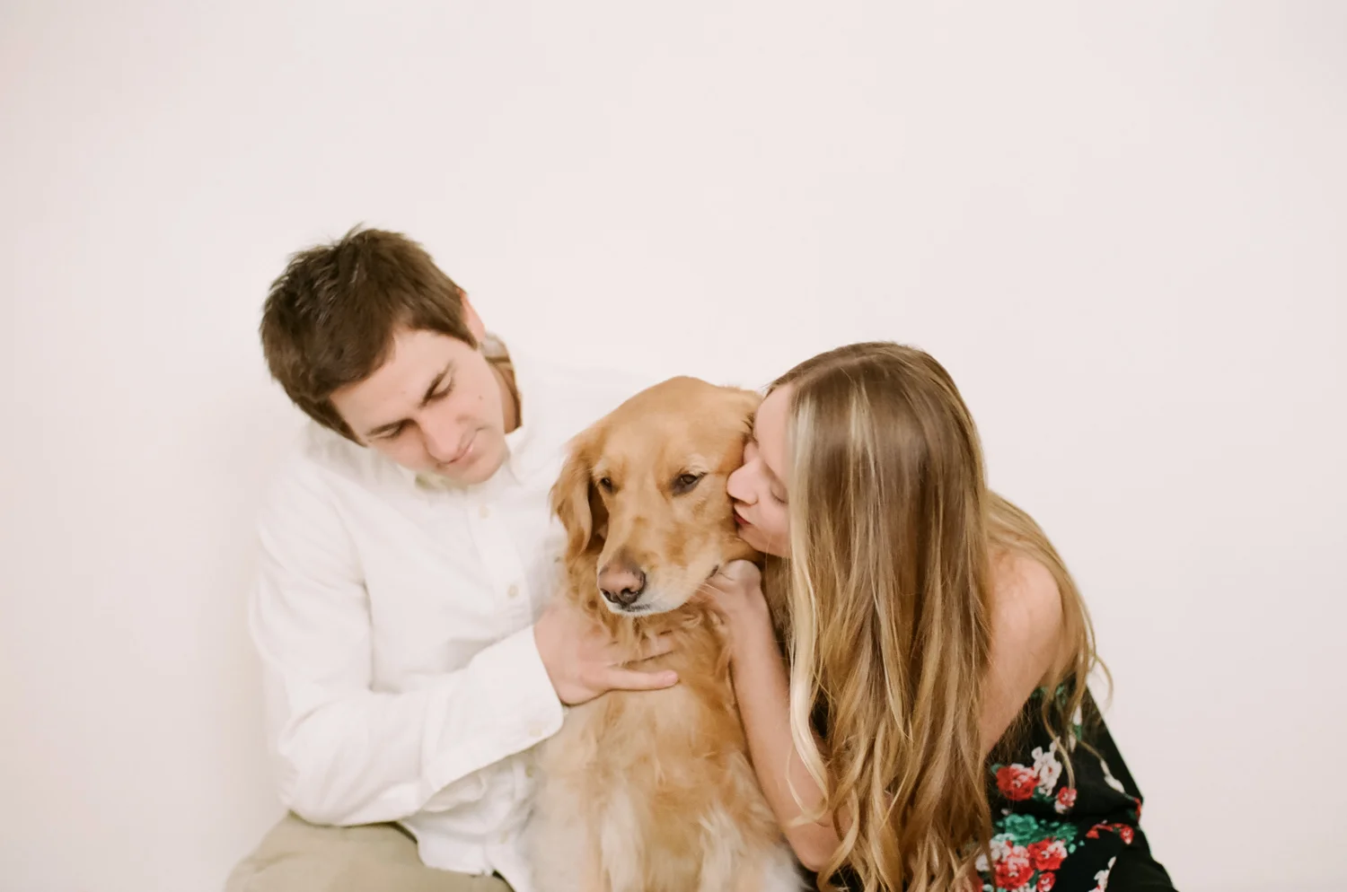 Lifestyle portrait of a couple with their golden retriever.