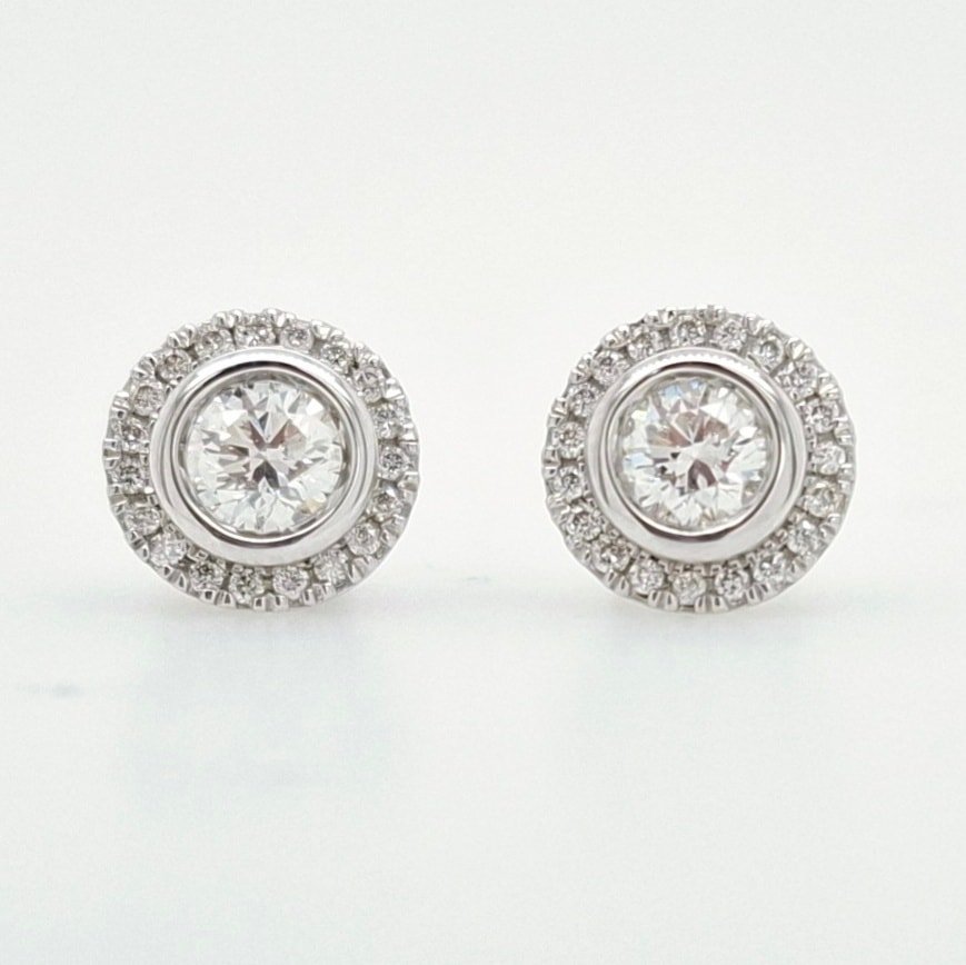 Versatile! These lab grown diamond studs feature a removable halo! How cool. 2 pairs in 1. You can wear the solitaire stud at work and then add the fancy halo for the evening .