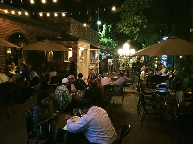 The warm glow of the patio at La Dolce Vita gives off the best warm weather vibes. Photo via La Dolce Vita