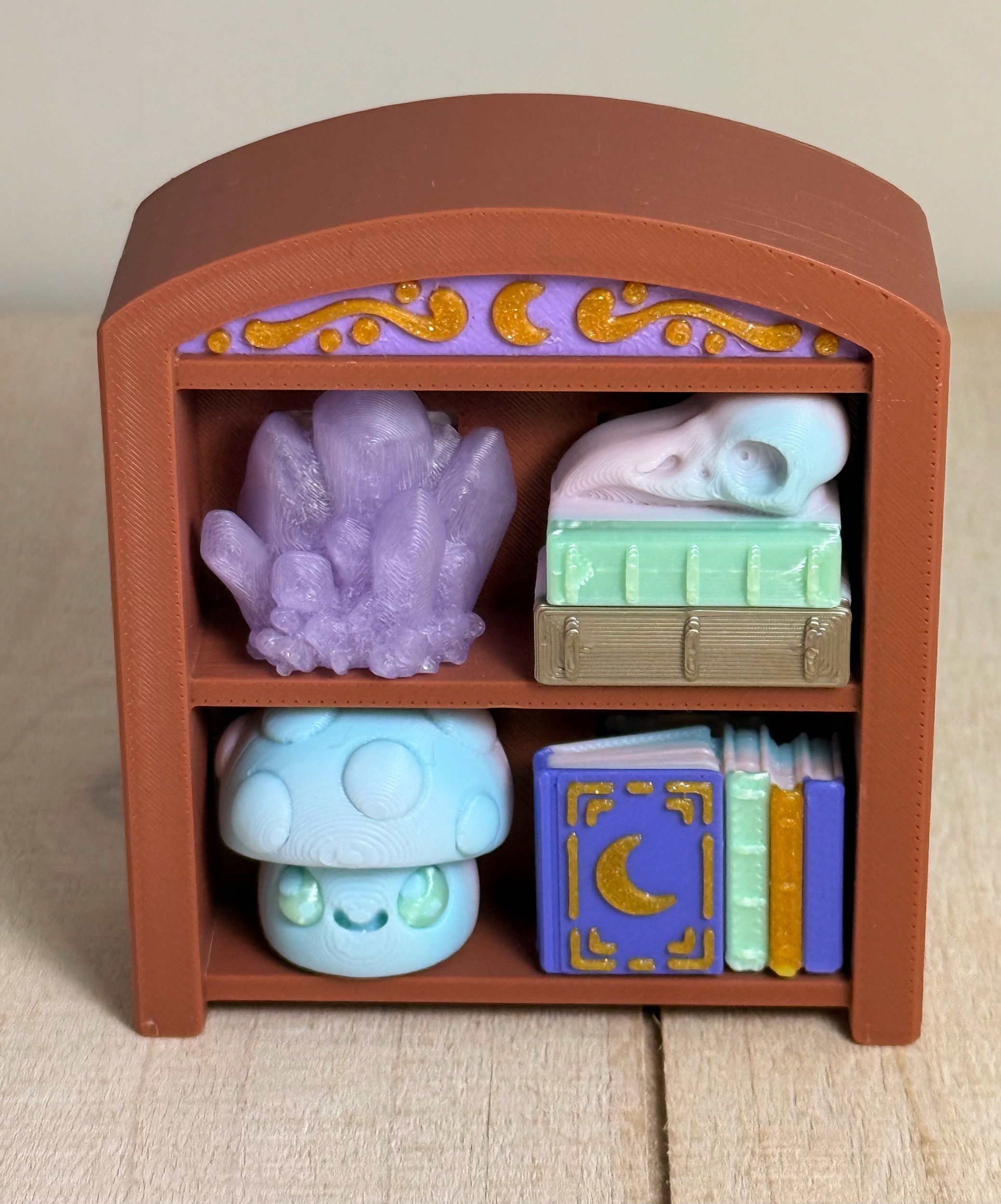 Whimsical 3D printed bookshelf with colorful shelf decorations
