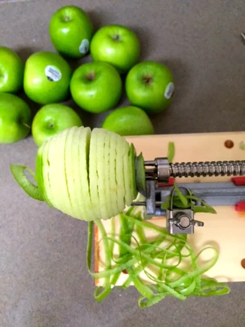 I start by coring, peeling, and slicing 5 lbs of Granny Smith apples. I love using Pampered Chef's Apple Peeler Corer & Slicer. It saves a ton of time, so you can start enjoying your pie sooner!