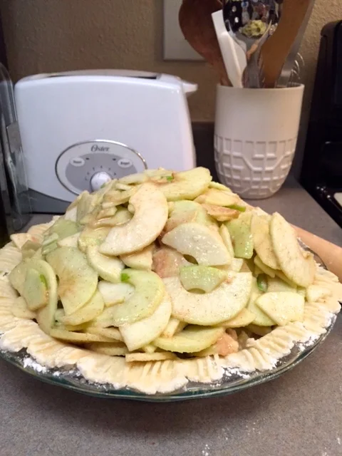 Now you can pile on those gorgeous apple slices. This is called the Mile High Apple pie for a reason, so don't be shy and stack em up nice and high!