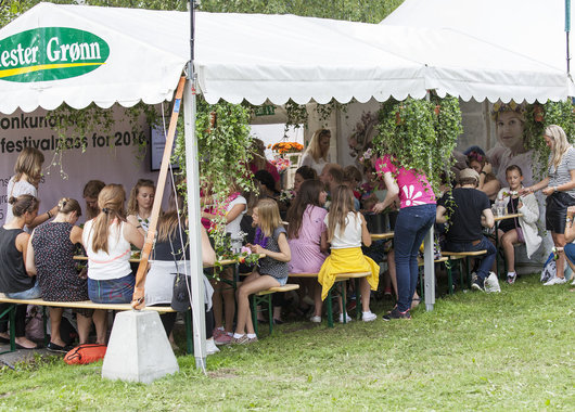 Bildene er fra Mester Grønns stand hvor de ansatte lærte festivaldeltakerne og lage blomsterkranser