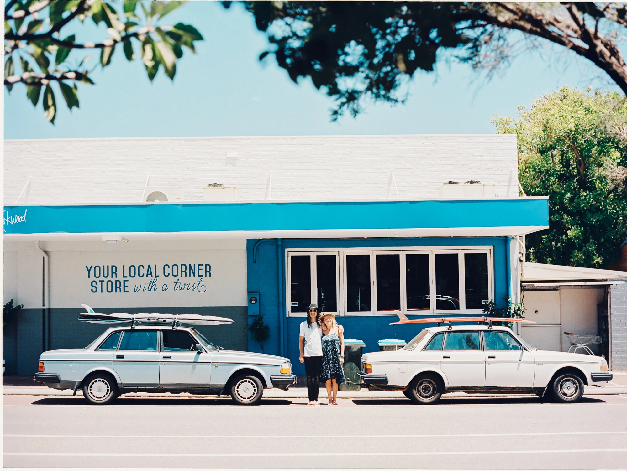 Jake and Annie and their cool cars Vera & Valley, 1992 and 1982 Volvos at the Kirkwood Corner Store after a morning surf down at Cottesloe.