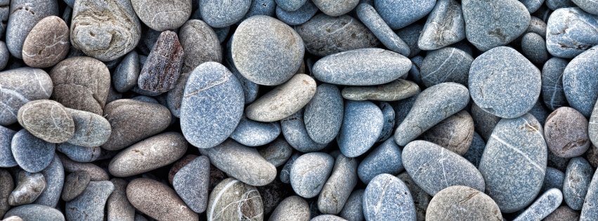 gray pebbles smooth stones pile banner website.png