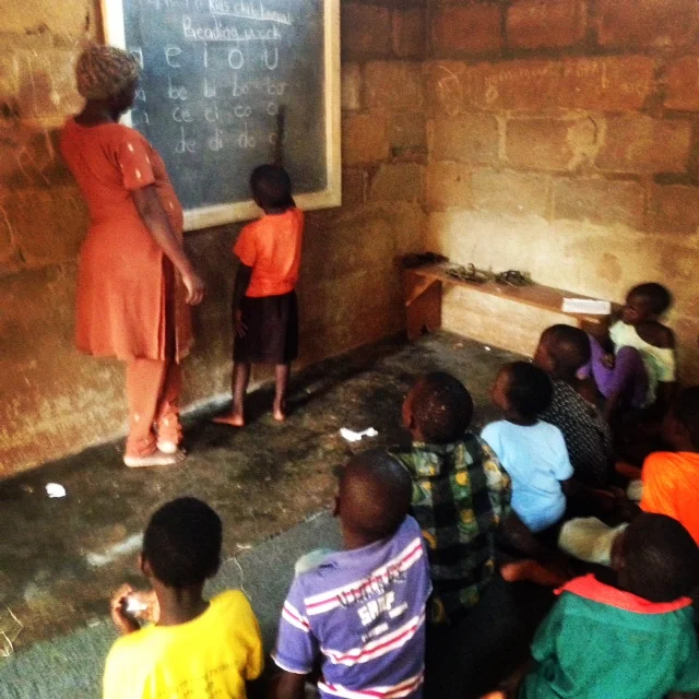 Children learning to read at the Encouraging Education Project.