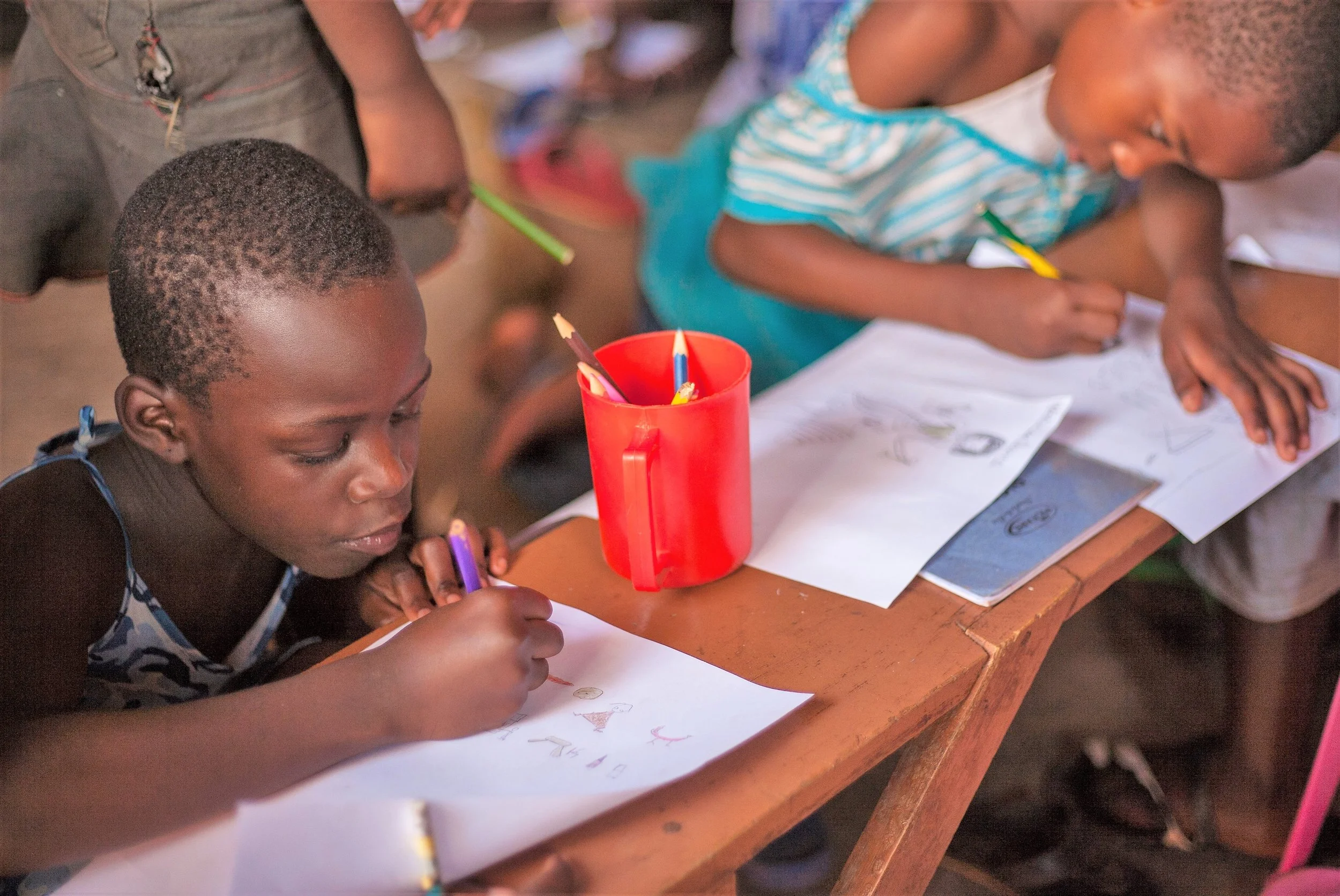 Children learning at Kids Club Kampala's Encouraging Education project