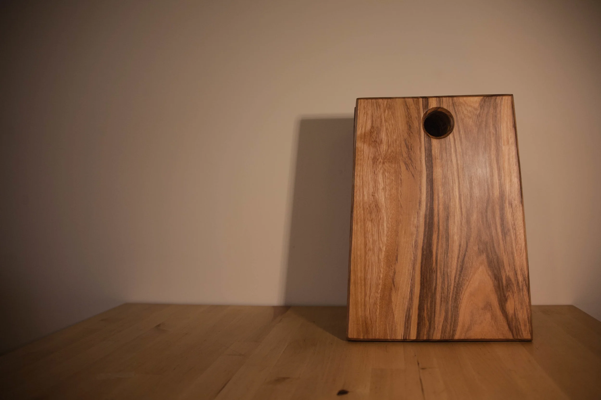 100% Solid Elgon Teak Chopping Board, Handmade in Uganda Back by popular demand! A solid Elgon Teak Chopping Board made from wood originating from the majestic Elgon Mountains in Uganda. Handmade at KCK’s Carpentry Project; sale of this item will directly benefit students at this Project. Value: £25