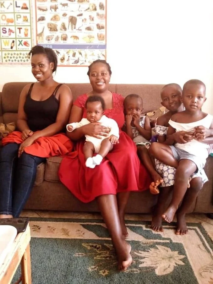 Gemma smiling happily with her foster family, 2020.