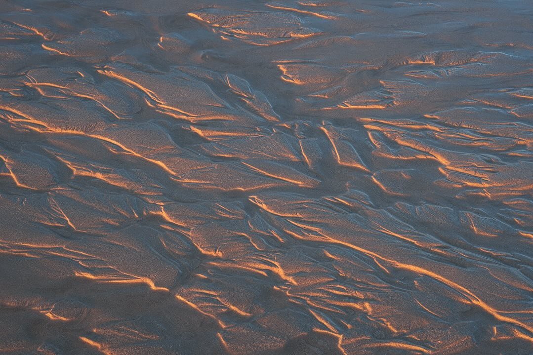 Fleeting Flow. As the river weaved out to sea, it carved these channels and islands in its wake. A tiny landscape of light and shadow set to be washed away as the next wave reclaimed the land.