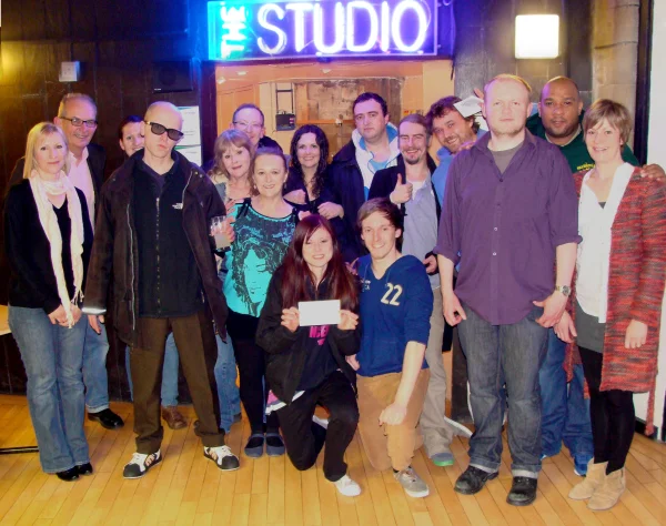 Christie (our newest company member) receives the cheque outside the York Theatre Royal studio entrance.