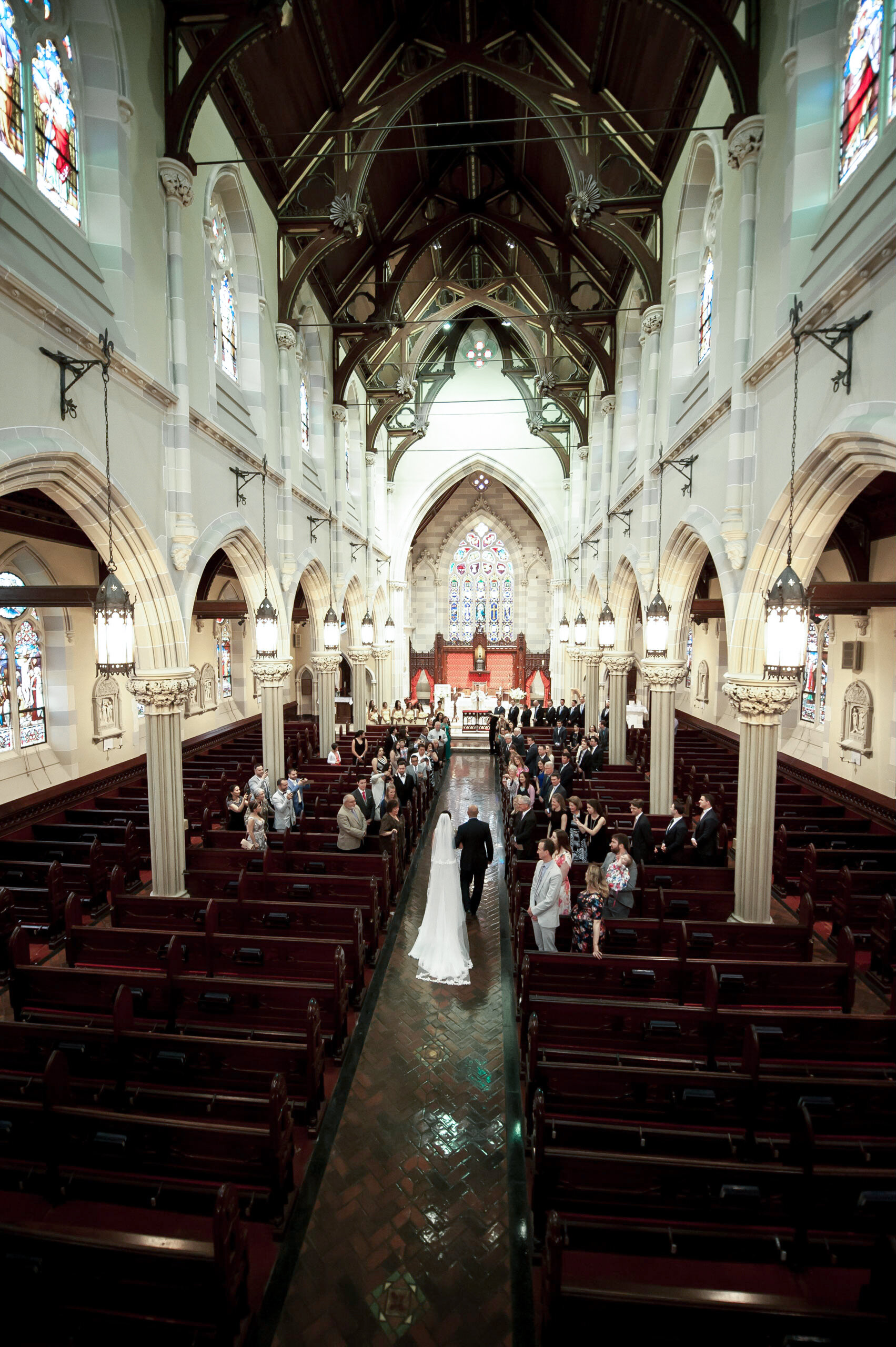 BRIDE WALKS DOWN THE AISLE AT ST MARYS CHURCH NEWPORT RI