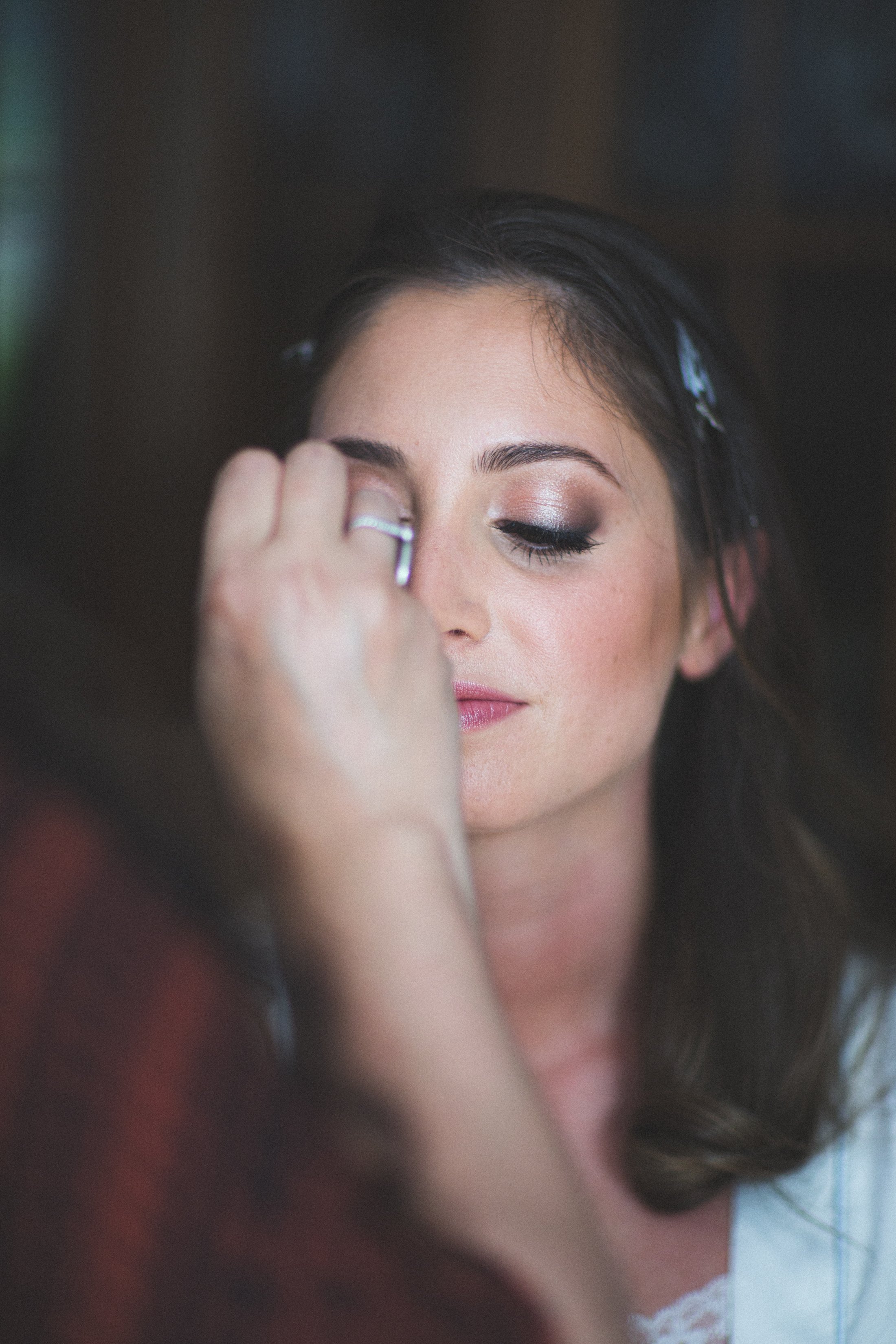 Bride gets her makeup done before her wedding