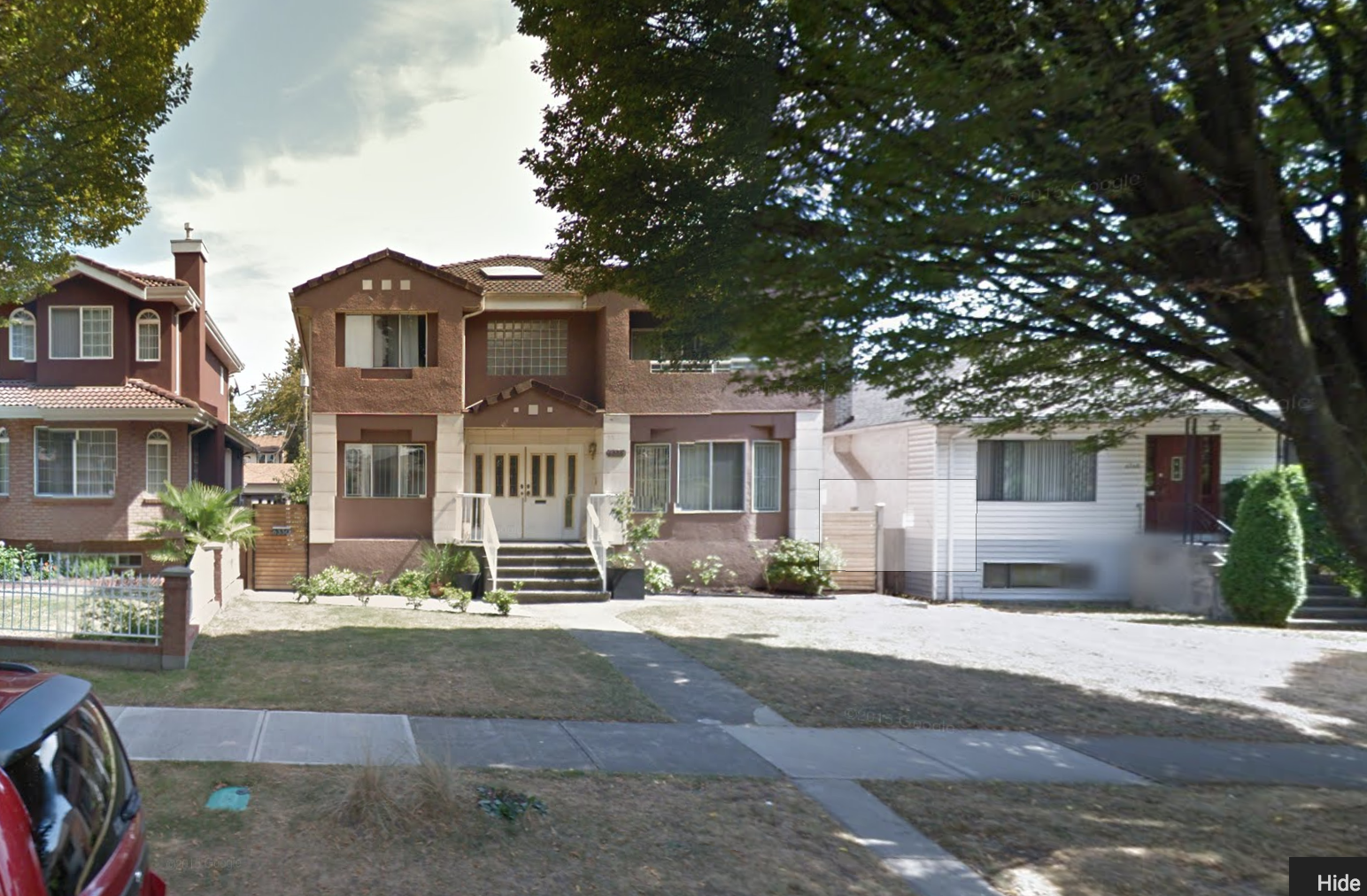 This is the same property as the photo above. The large, and largely formal, front yard isn't allowed to contribute any functionality to the 3 dwellings on the site. Photo: Google