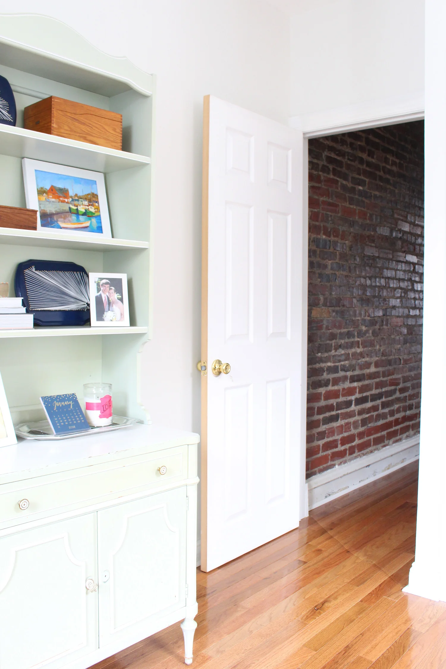 Door from the office to the exposed brick hallway.