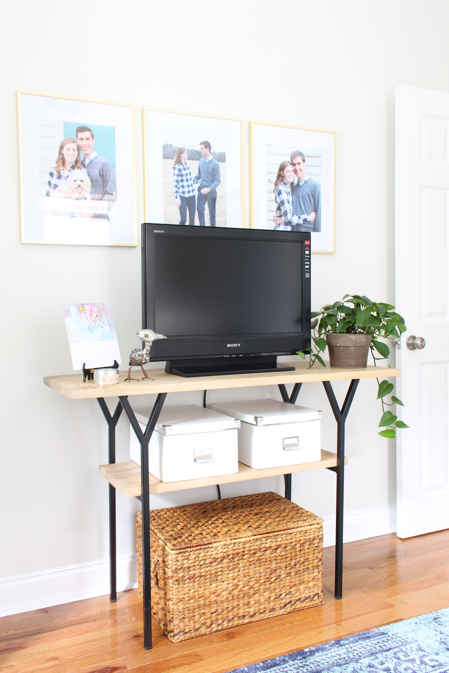 Using a console table as a TV stand in a home office.