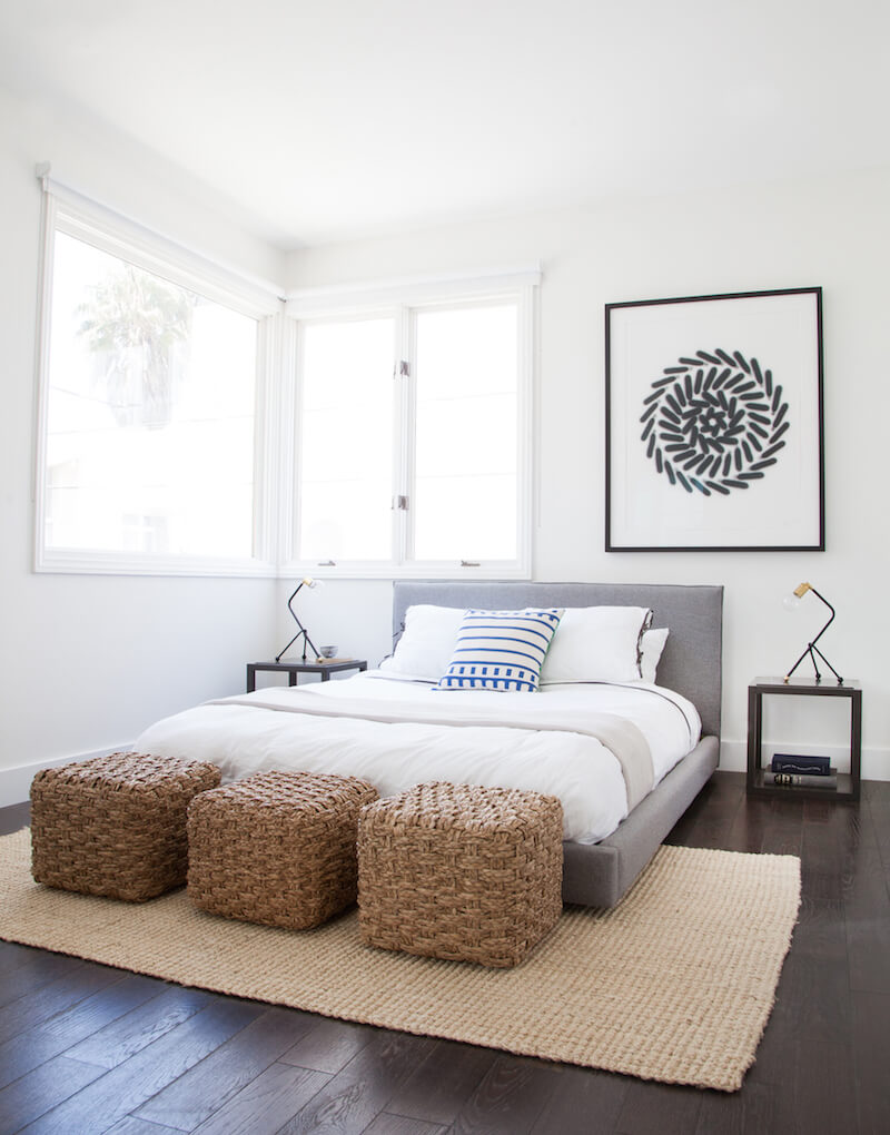 Use art to add balance to an off center window in a bedroom. 
