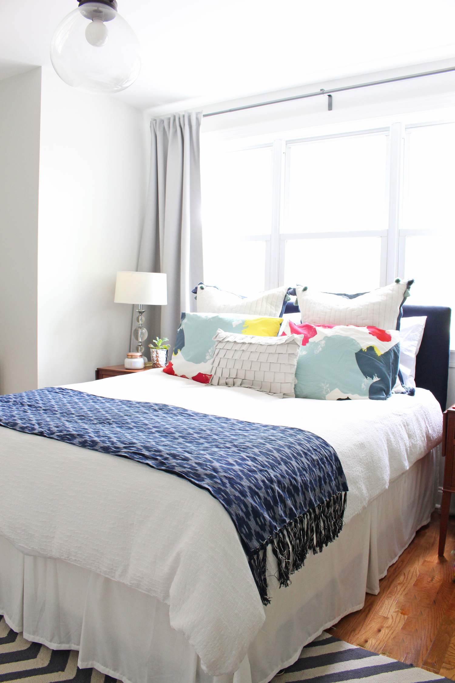 Mix & Match Design Company's light and airy eclectic master bedroom. Blues, whites and grays form the primary color palette in this peaceful room.