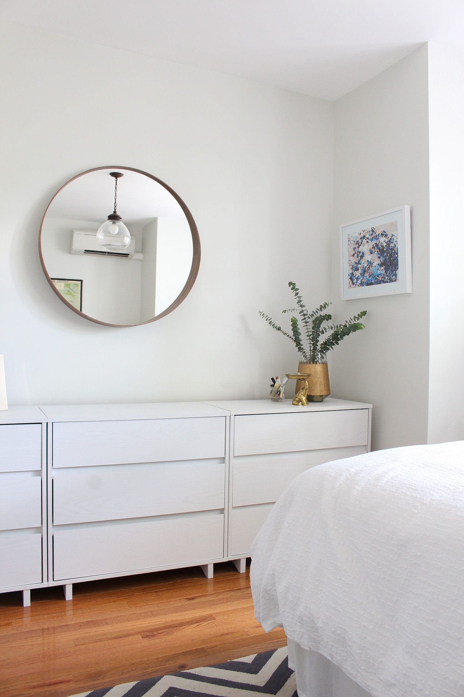 Art from Art Crate (Artist: Katie Craig) hangs over these modern, minimalist dressers.