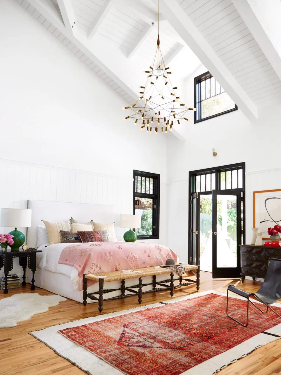 How to decorate around a bed: leave the walls blank! Let the architecture shine. // colorful bedroom, eclectic bedroom, pink bedroom, boho bedroom, bohemian eclectic bedroom