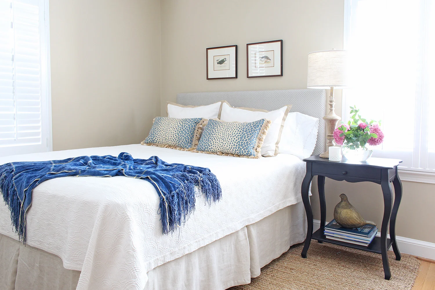 A traditional guest room gets a new look with a custom DIY upholstered headboard along with some other pieces from around the house.