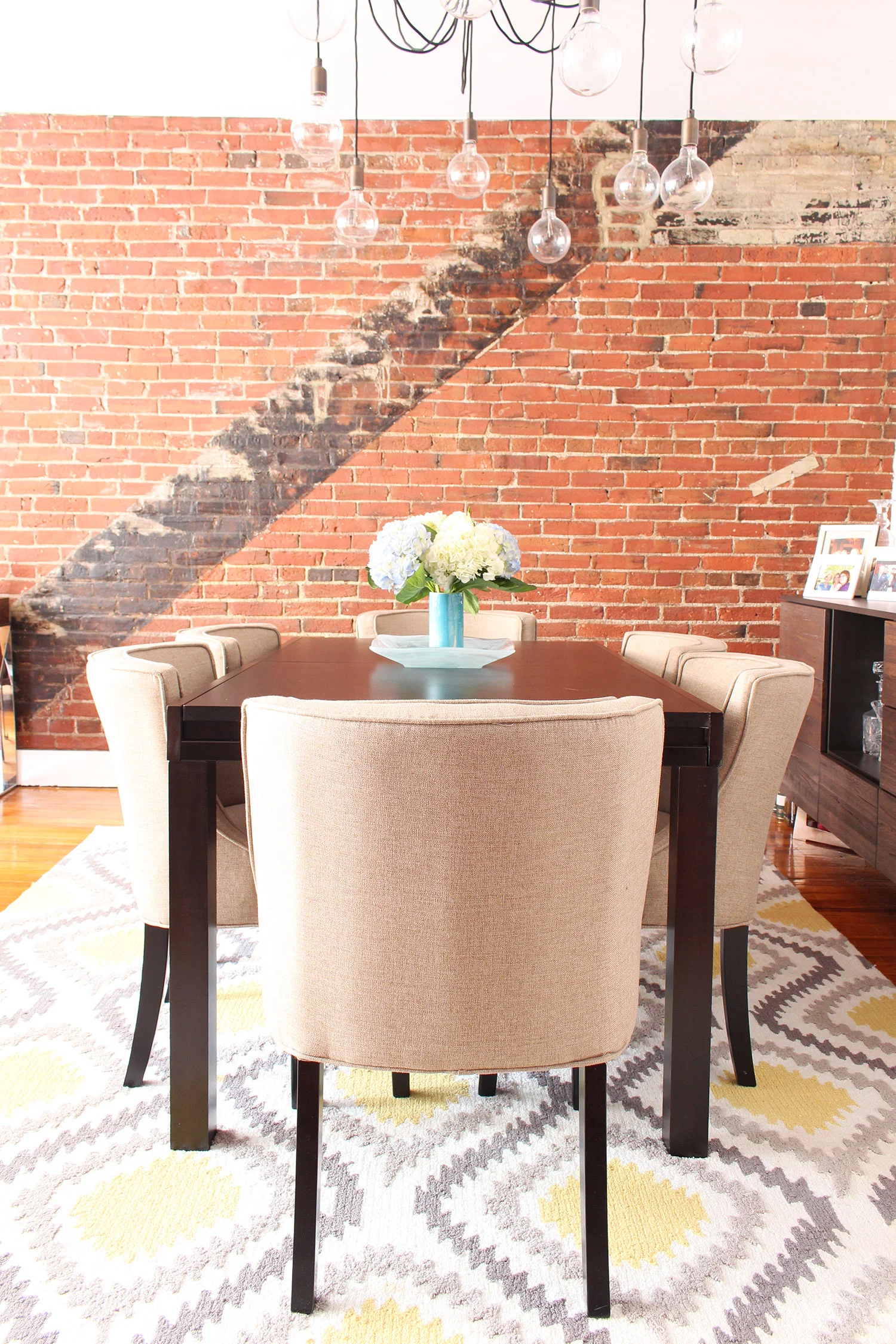 Contemporary meets classic in this converted textile factory condo's dining room in Philadelphia // contemporary dining room, transitional dining room, exposed brick
