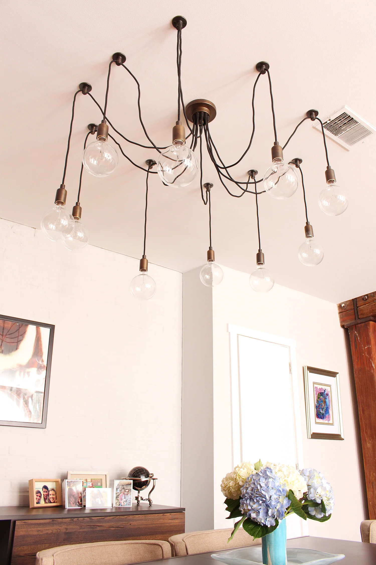 Contemporary meets classic in this converted textile factory condo's dining room in Philadelphia // contemporary dining room, transitional dining room, exposed brick