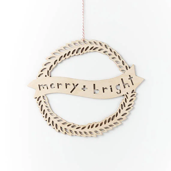 Shop small for Small Business Saturday! This post has a roundup of some of the best Etsy shops for home and decor. (Laser cut merry and bright wood wreath from Light & Paper)