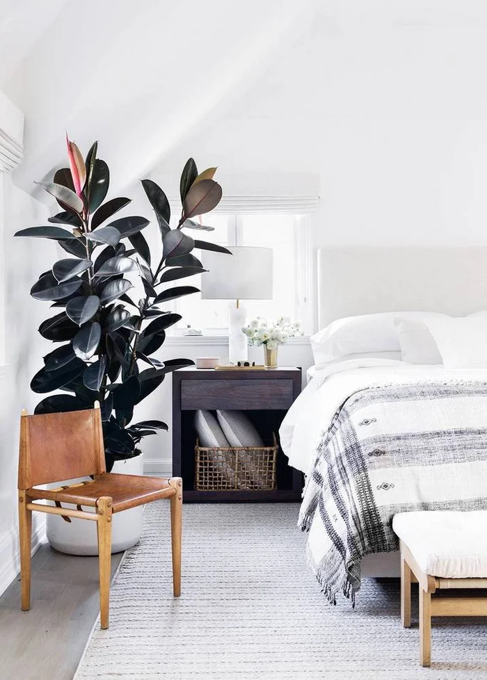 This beautiful modern meets Scandinavian bedroom is full of texture, neutral bedding and textiles, and warm woods. Plus, how amazing is that plant in the corner!?