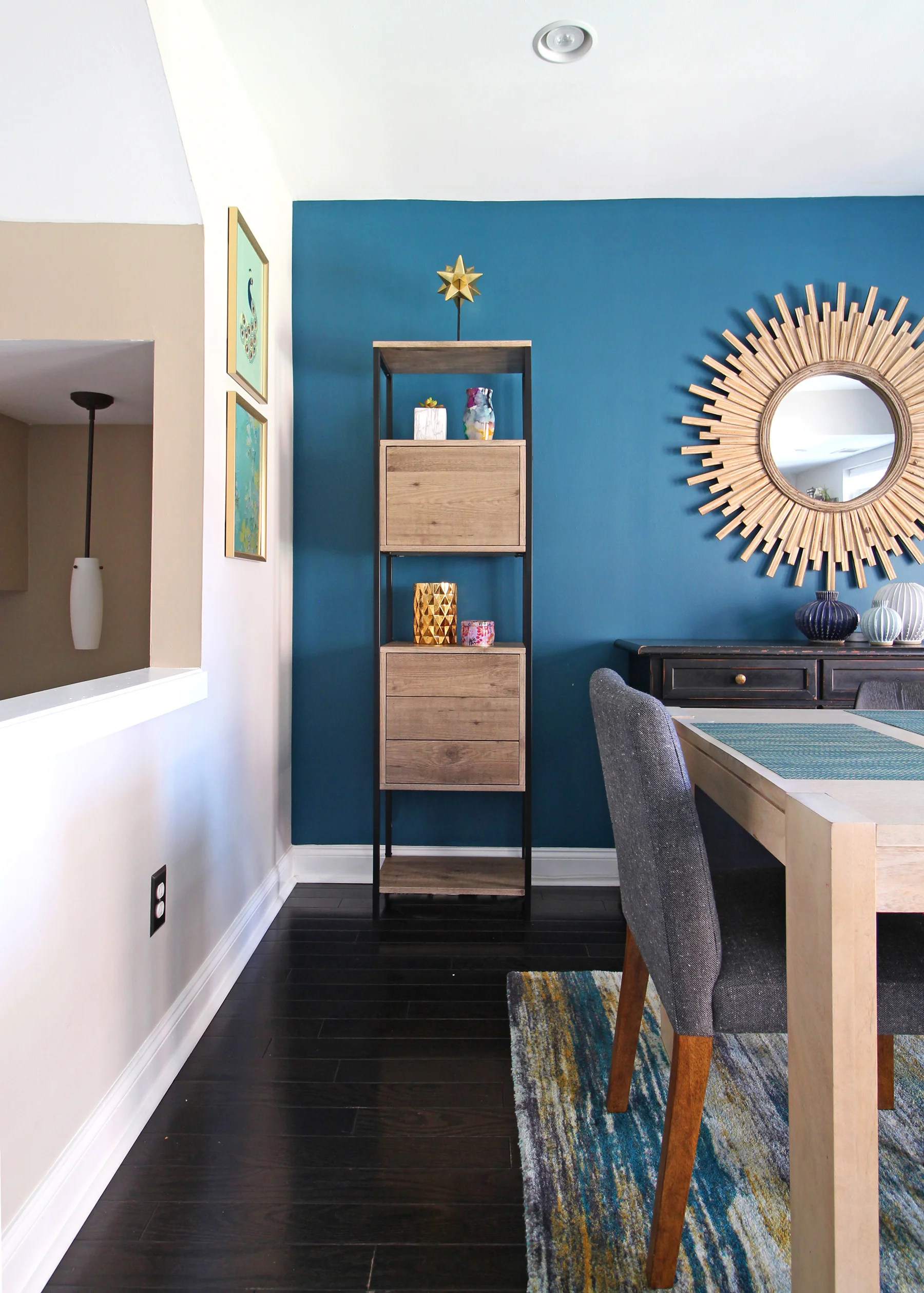A cozy modern dining room in the heart of Philadelphia. The teal accent wall paired with light wood accents makes for a stunning and functional space for a family of four. Design and photography by Mix & Match Design Company.