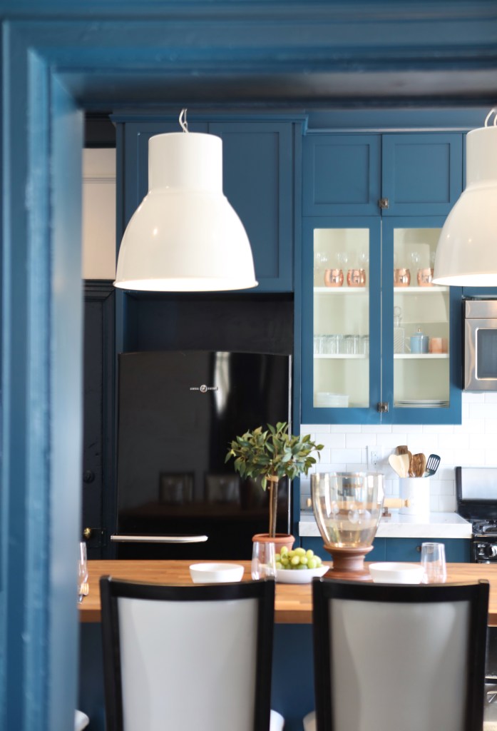 Old Home Love's One Room Challenge Fall 2017. I love this blue kitchen with the modern white pendant lights over the butcher block counters!