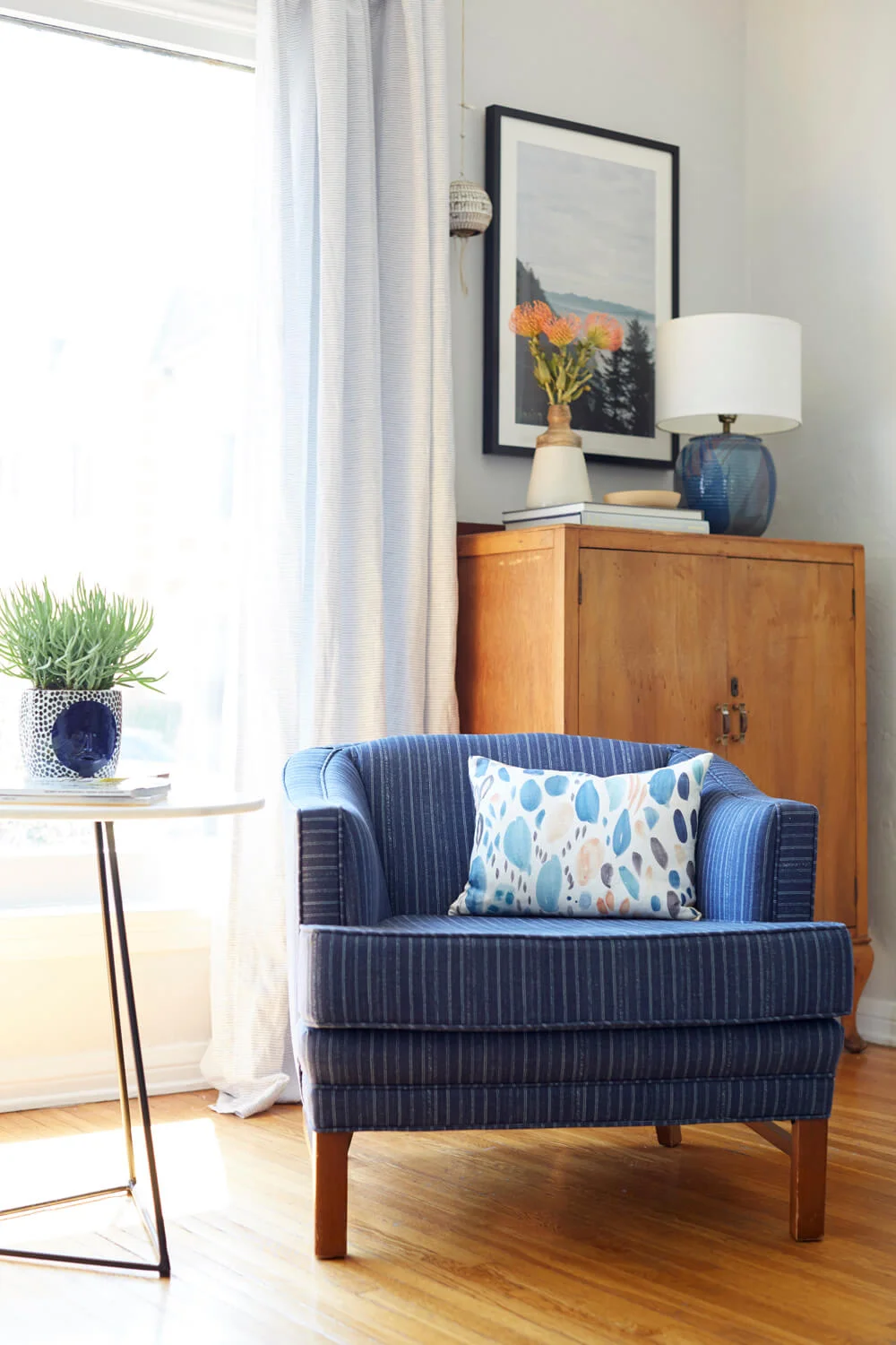 Inspiration for Mix & Match Design Company's guest room makeover for the One Room Challenge. Love the mix of old and new in this living room. The blue striped chair plus the antique cabinet in the corner is perfection!