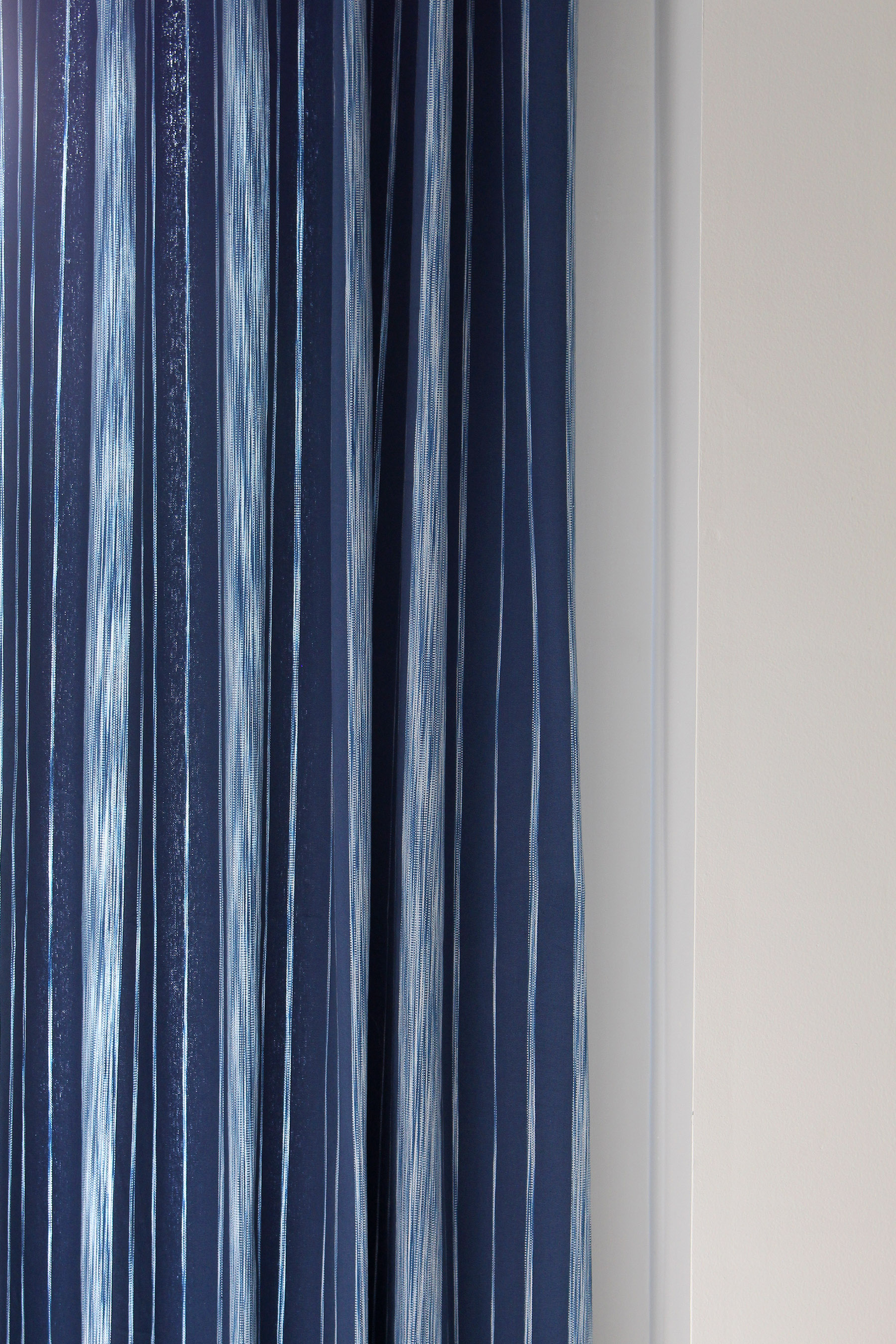 Close up of the Pizzelle Navy fabric from Calico's Vern Yip collection. See it here as a made into a beautiful curtain panel in this guest room.