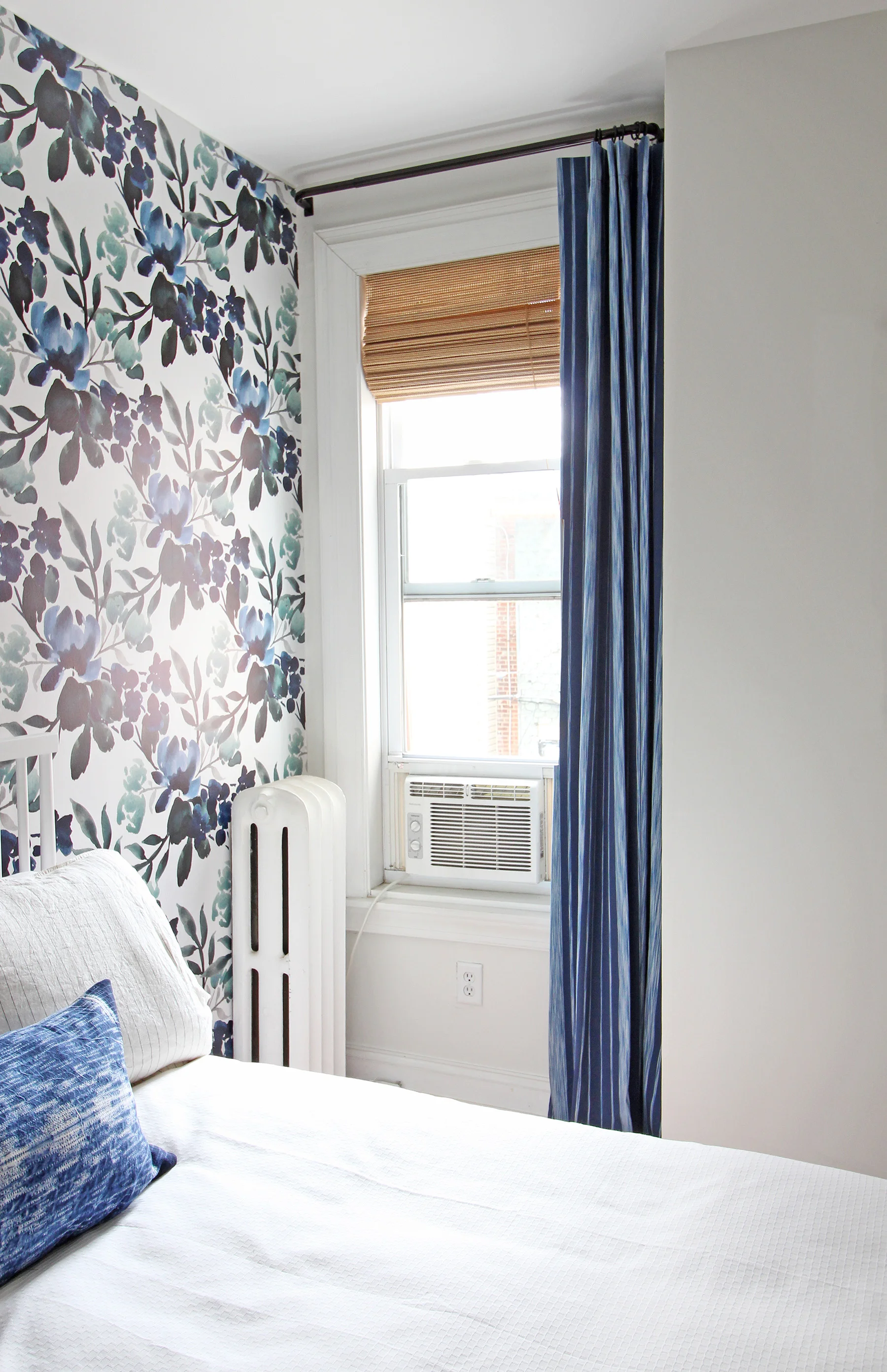 Here's a peek of the progress on this One Room Challenge Guest room! A new blue striped curtain went up this week (custom made) along with a woven roman shade. These complement the bold blue and green floral wallpaper beautifully.