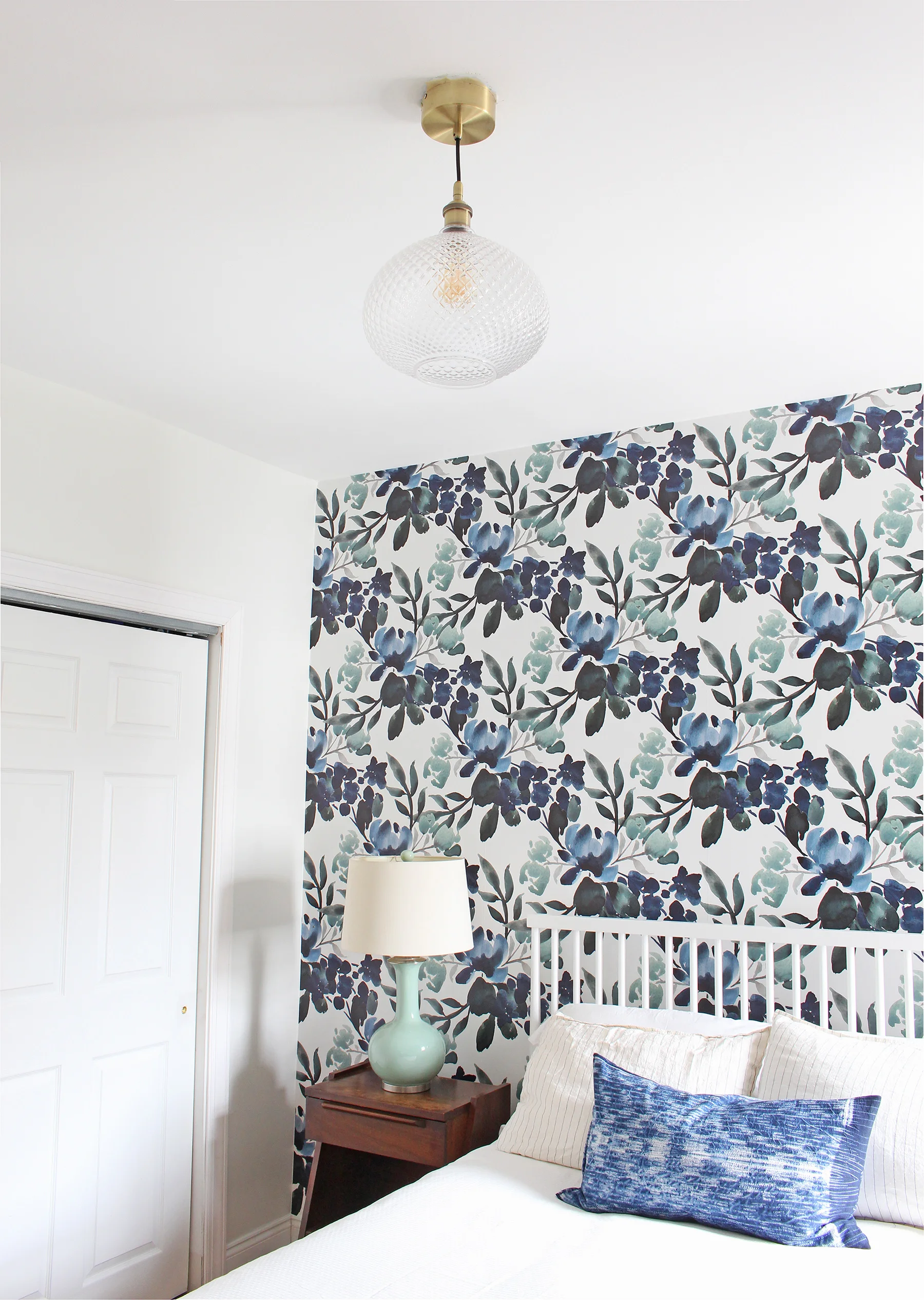 Catch a glimpse of the progress in this One Room Challenge Guest Bedroom. This week, a new cut glass pendant light from Lamps Plus went up! It's the perfect subtle, but unique touch to complement the blue and green floral wallpaper.