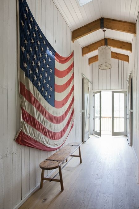 How to use American flags as decor. Hang a vintage American flag on the wall.