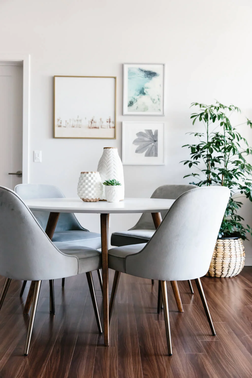 Modern minimalist dining room with gray chairs and white walls