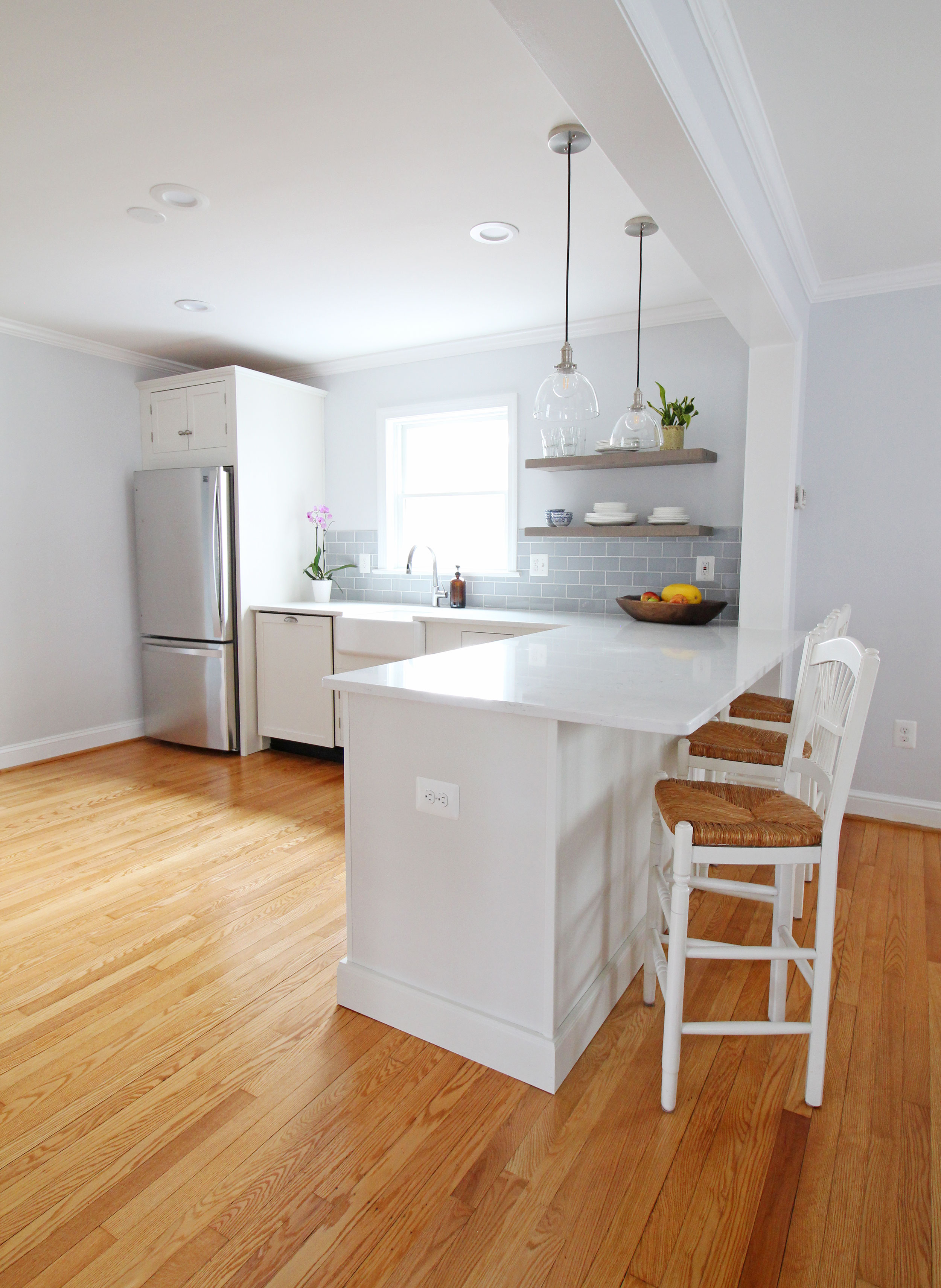 Open shelving in a white kitchen in this transitional farmhouse Arlington, Virginia home. // Pros and cons of open shelving // Design: Mix & Match Design Company