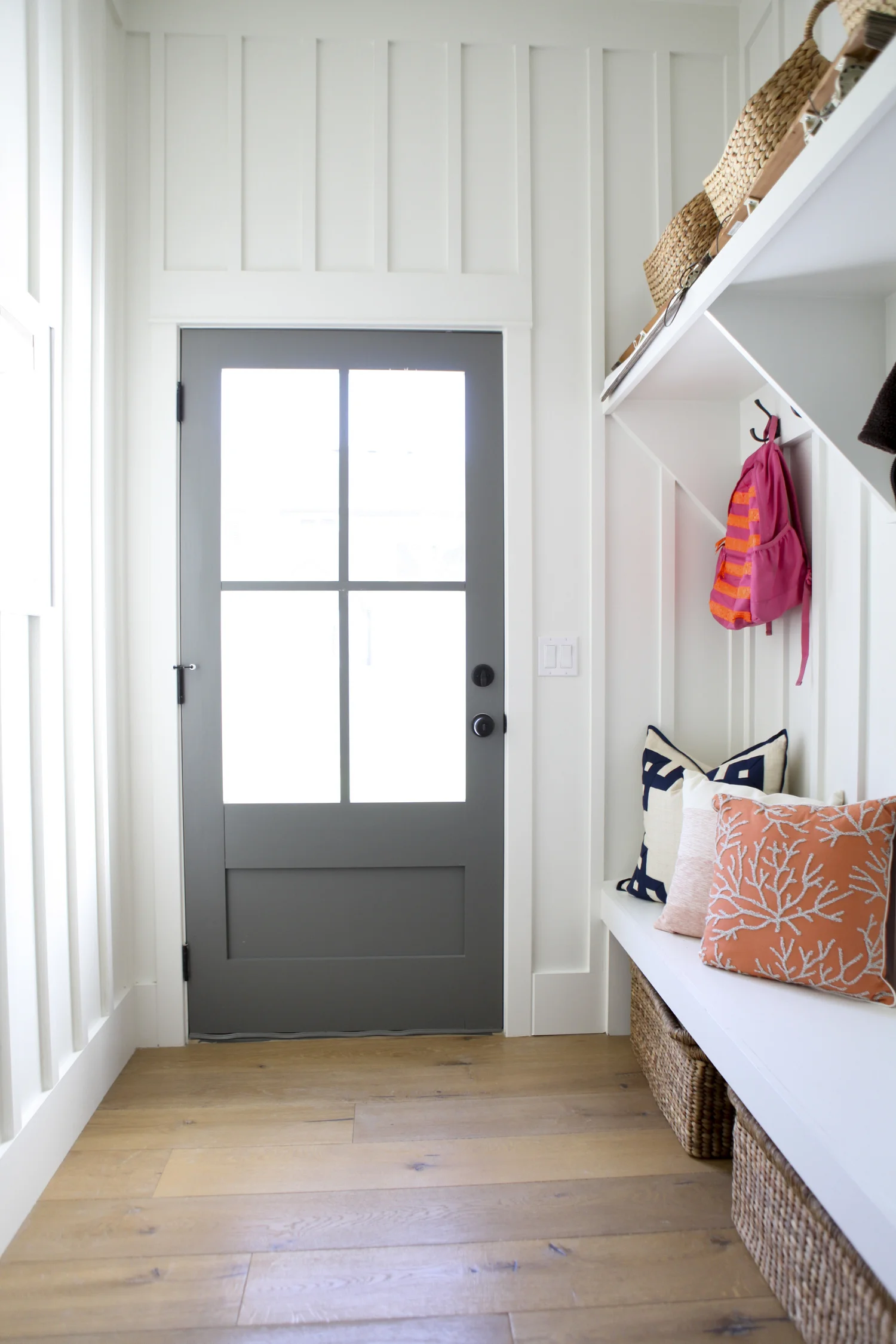 A built-in bench in this entryway/mudroom makes for a great drop zone and storage area. I also love that gray door. For more ways to use benches in your home, be sure to head to the blog post!