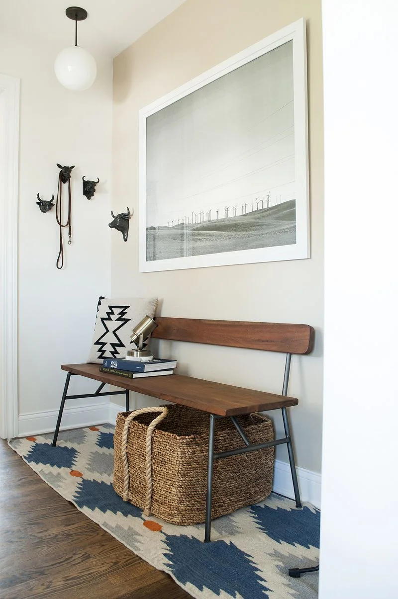 A modern bench from CB2 makes for a functional and pretty entryway in this home. For more ways to use benches in your home, head to the blog post!