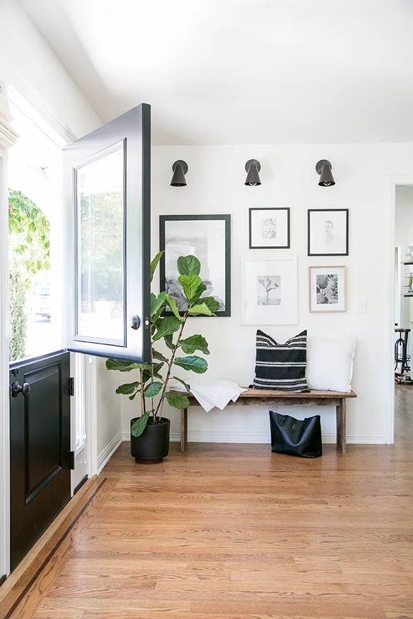 A simple bench with a gallery wall above makes for a perfect entryway and a great drop zone. For more ways to use benches in your home, check out this blog post!
