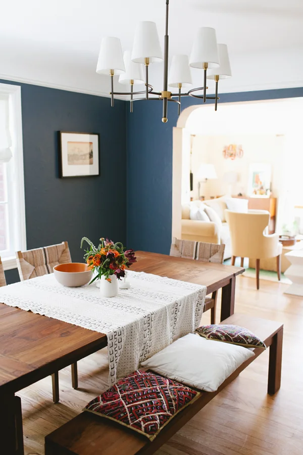 A bench mixed with chairs works beautifully in this blue dining room. For more ways to use benches in your home, head to this blog post!