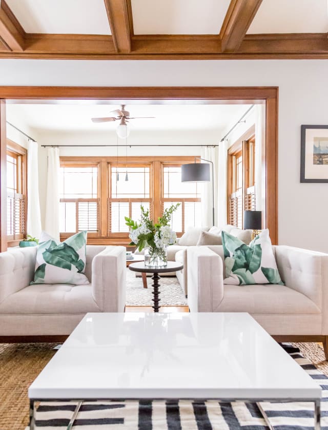 Working with wood trim can be a challenge, but this transitional modern living room proves that it can be done well! They kept things bright and airy with white and light colored furniture and decor.
