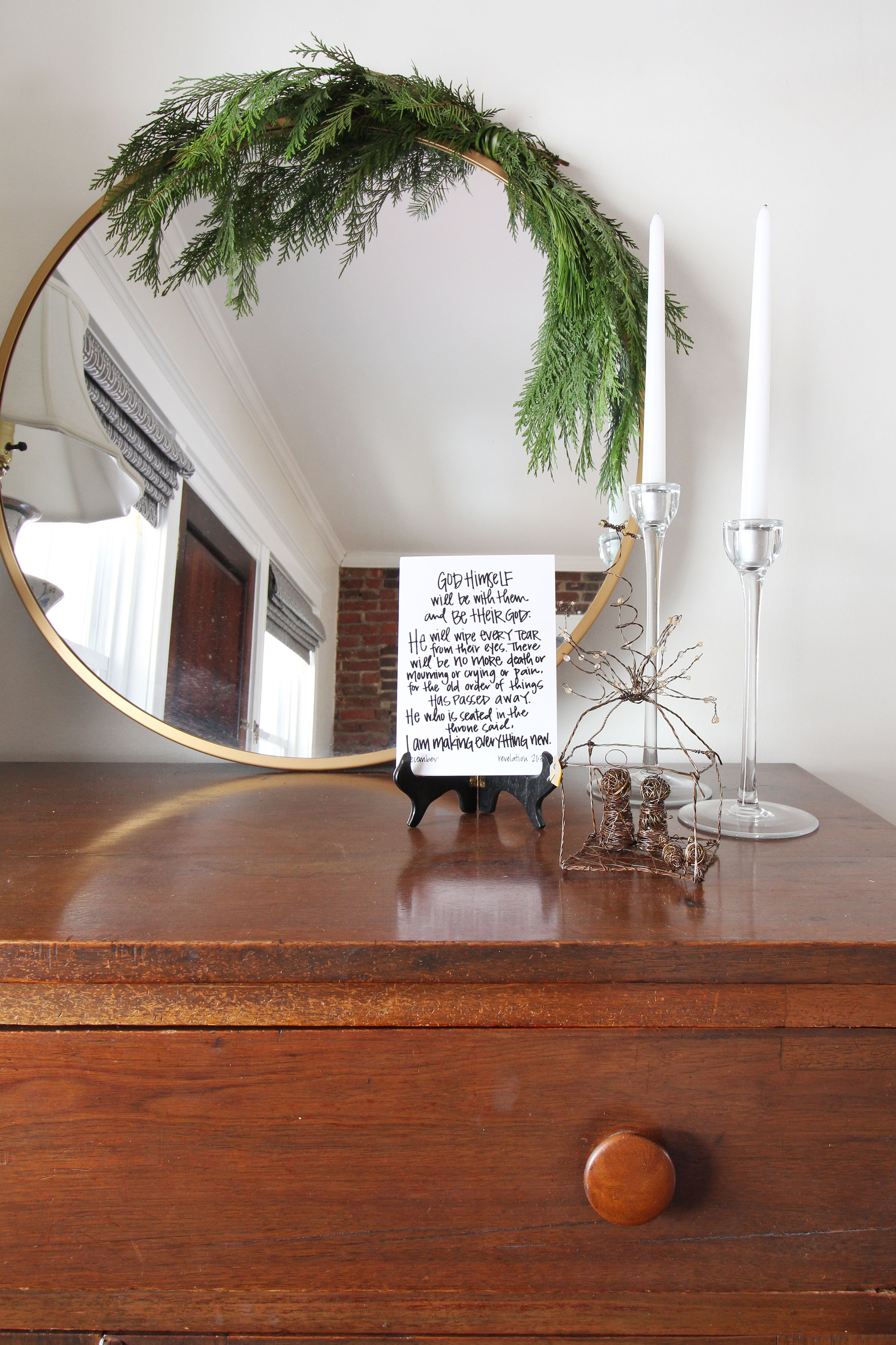 A simple way to add a little bit of Christmas cheer in your home is to hang greenery over a mirror. Here, I added some cedar and pine branches to our round brass mirror. It’s the perfect touch of holiday spirit for this spot. Christmas decorating can be simple and easy!