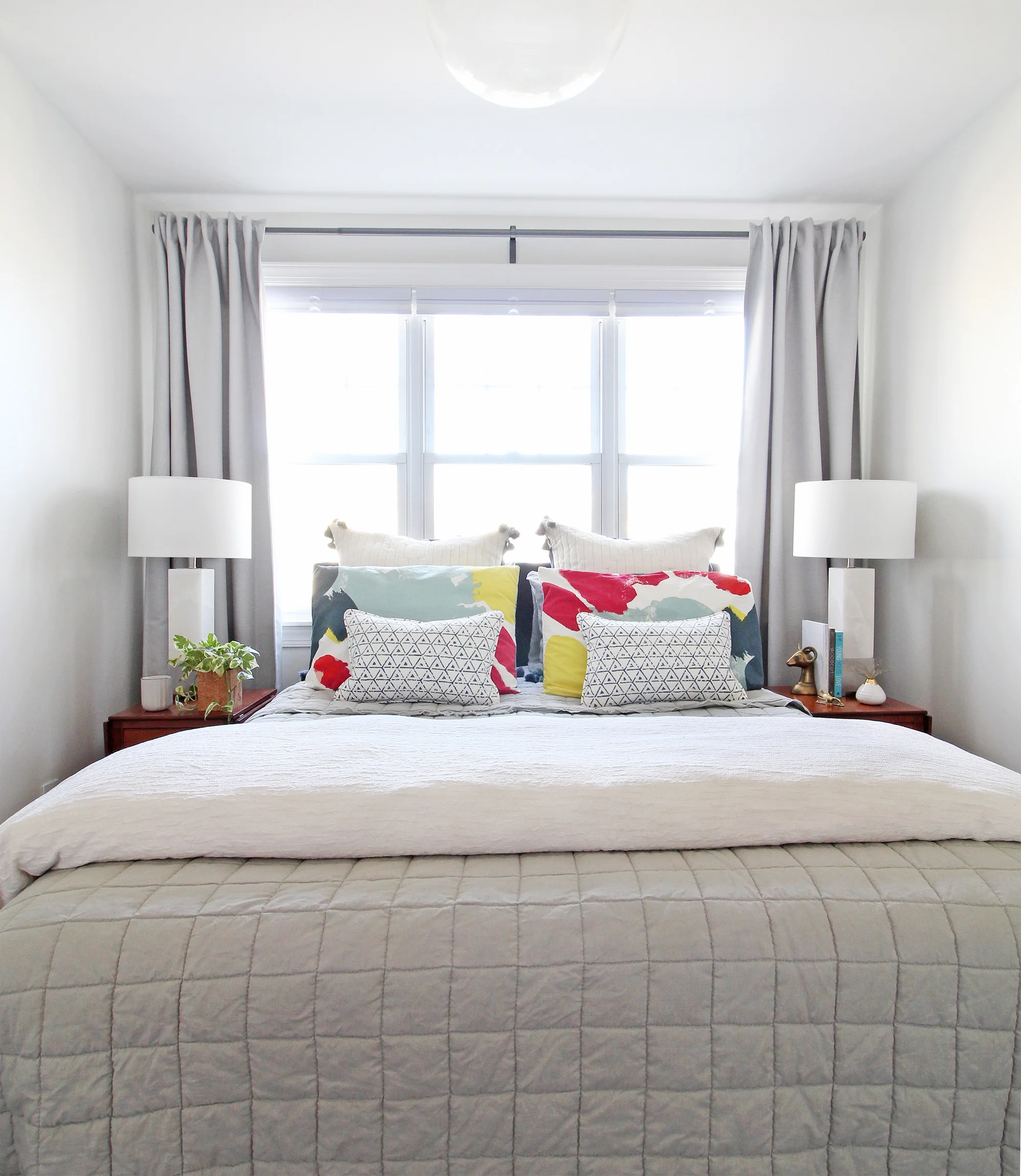 Installing cordless cellular shades from Affordable Blinds was an easy way to add privacy to our master bedroom! The white top-down bottom-up shades add so much functionality and basically disappear when they’re raised all the way up. I love them layered with our curtains in our modern eclectic master bedroom.