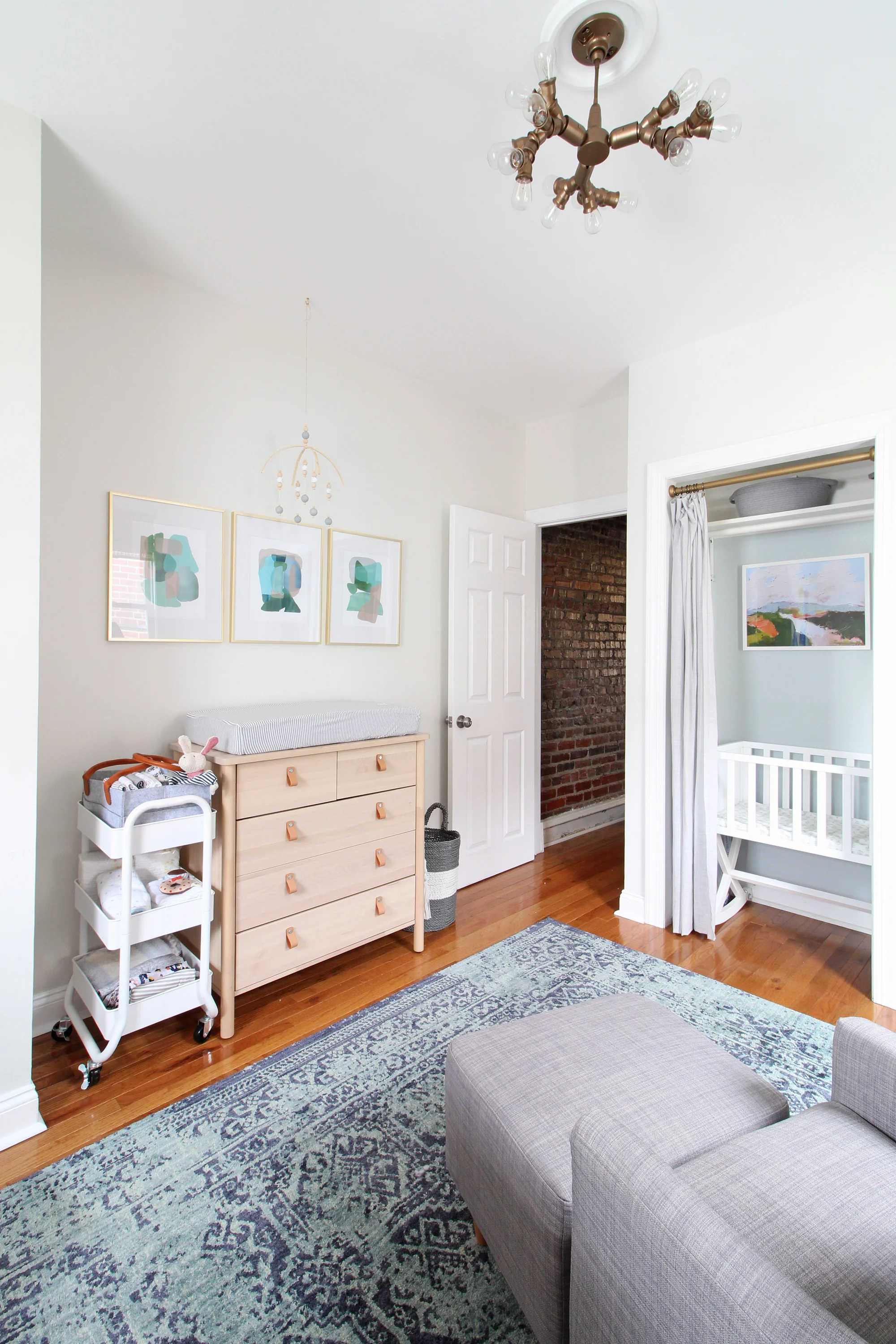 Come on over to the Mix & Match Design Company blog for this cozy modern nursery nook reveal! This space is shared with a home office and is full of great ideas on how to squeeze in a small nursery into a closet. The “nursery nook” concept is perfect if you live in a smaller home. Bassinet in closet.