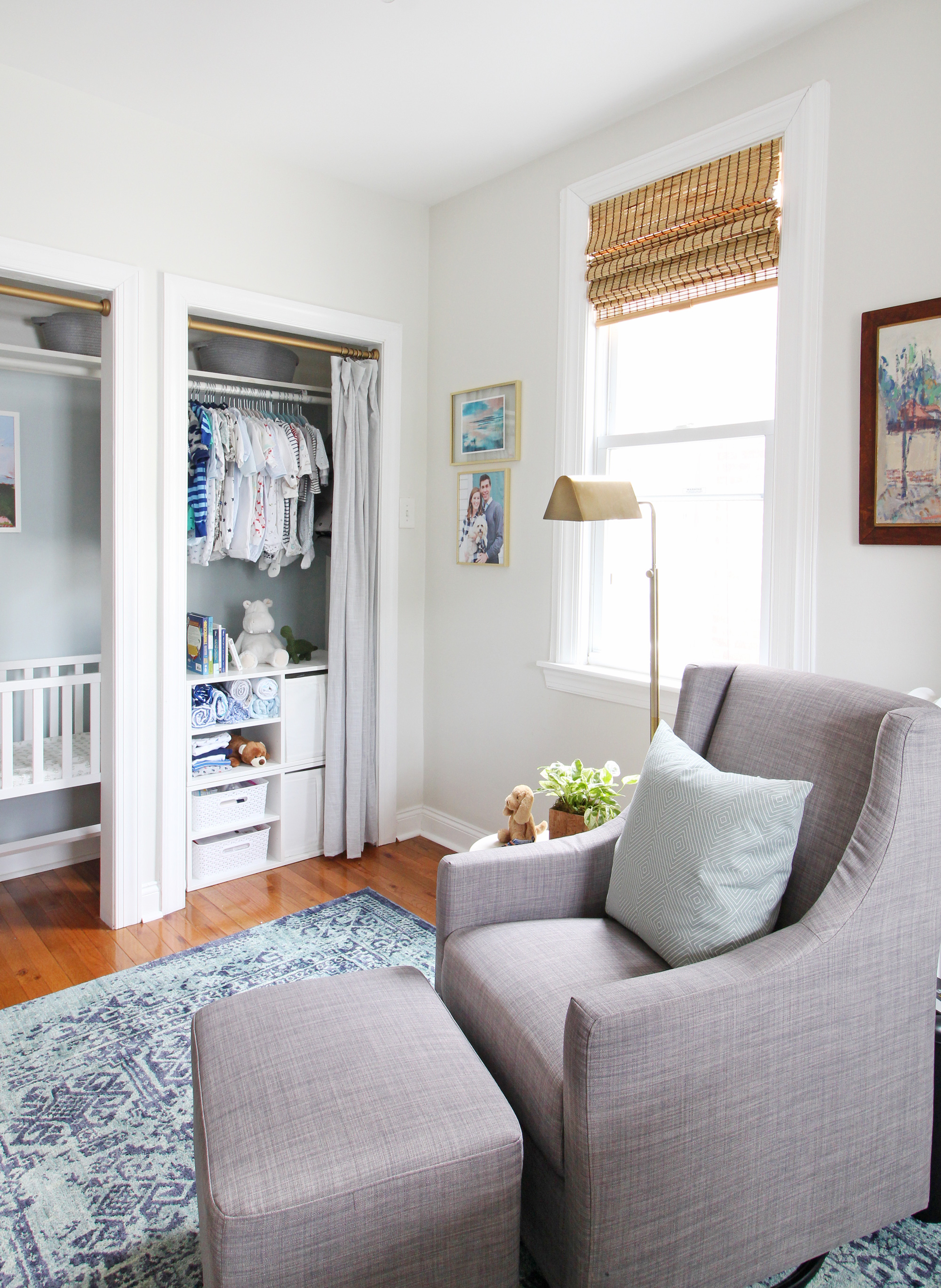 Come on over to the Mix & Match Design Company blog for this cozy modern nursery nook reveal! This space is shared with a home office and is full of great ideas on how to squeeze in a small nursery into a closet. The “nursery nook” concept is perfect if you live in a smaller home. Gray glider in a blue nursery.