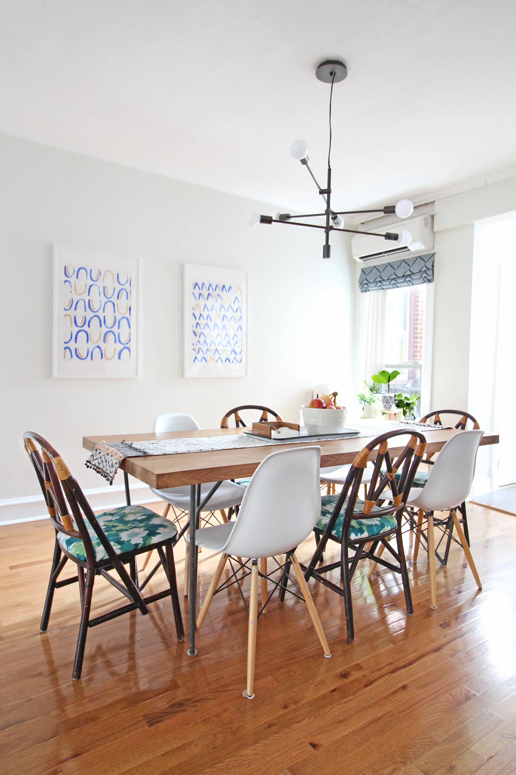 A 1930s row home in Philadelphia gets a big makeover. Come see the before and after of this home’s living, dining, and kitchen open floor plan and get ideas for small space city living. Chaney’s style is mid-century modern meets traditional that makes for an eclectic, cozy space. The dining table was a Craigslist find and her mix of dining chairs continues the eclectic vibe.