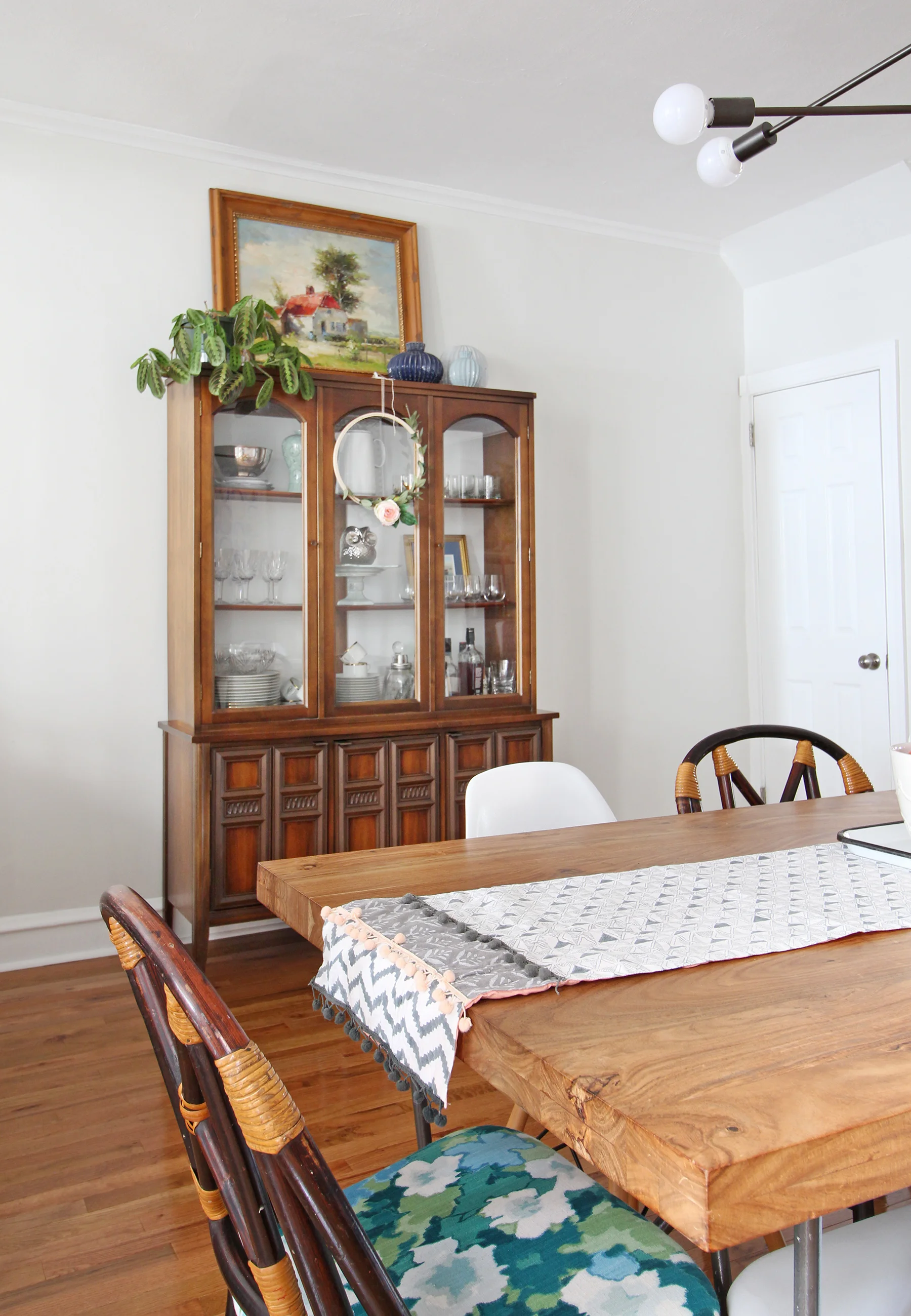 A 1930s row home in Philadelphia gets a big makeover. Come see the before and after of this home’s living, dining, and kitchen open floor plan and get ideas for small space city living. Chaney’s style is mid-century modern meets traditional that makes for an eclectic, cozy space. A dining table for 8 and a mid-century storage cabinet complete the dining area.
