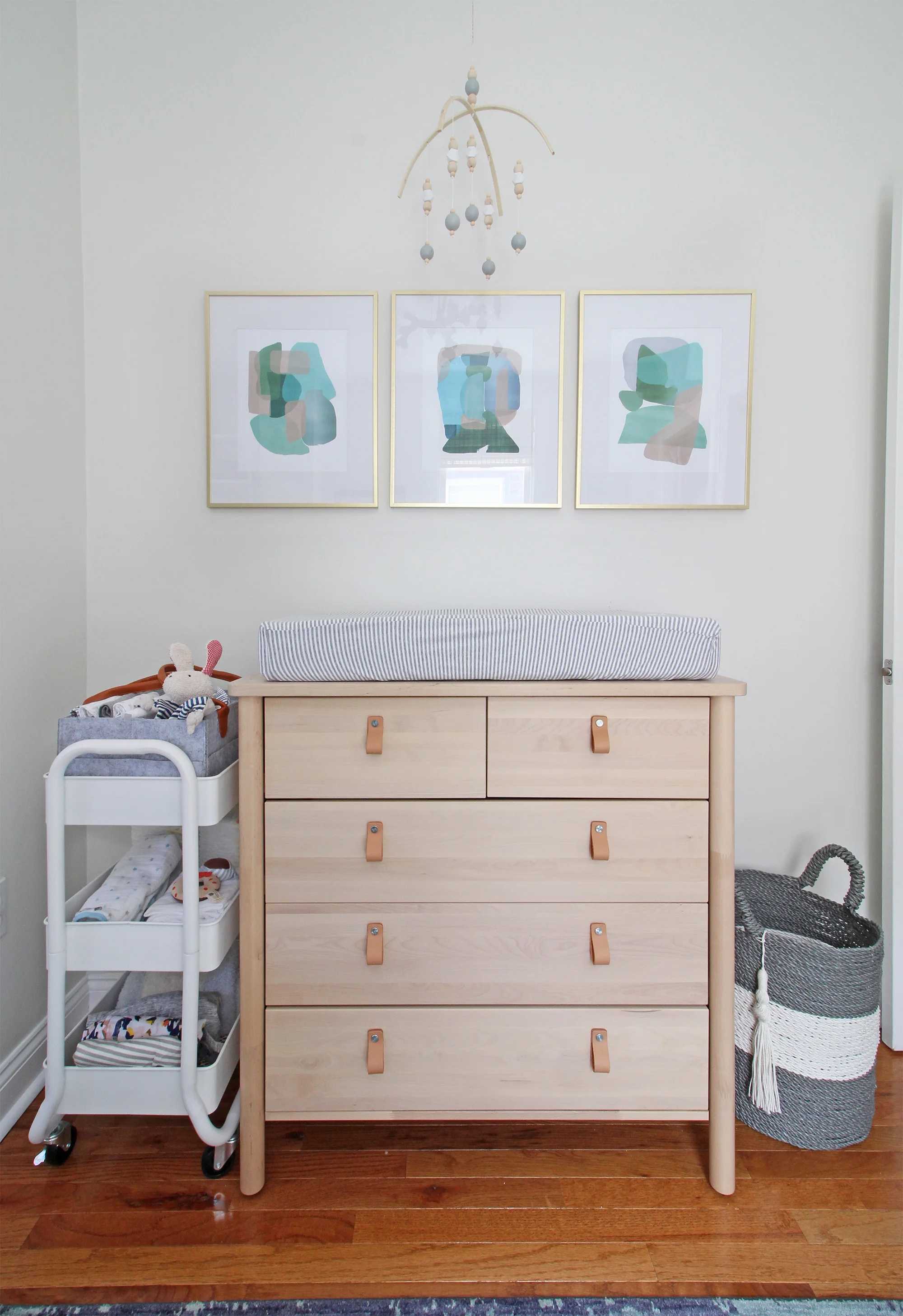 A 1930s row home in Philadelphia gets a big makeover. Come see the before and after of this home’s bedrooms, small bathroom, and office/nursery nook. Get ideas for small space city living! This nursery is shared with a home office and has a cozy modern style.